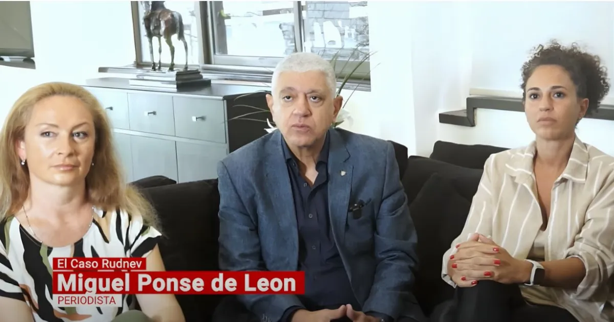 Interview with three seated individuals.